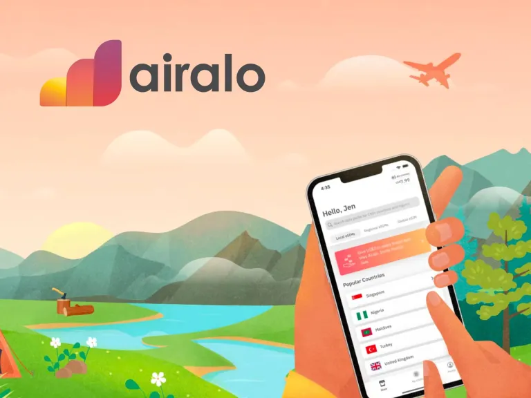 a person holding a phone with a plane in the background
